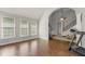 Sunroom with hardwood floors, ample windows, and an arched entrance to the living area at 4680 Brighton Lake Dr, Cumming, GA 30040