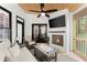Relaxing sunroom with fireplace, ceiling fan and comfortable seating at 4680 Brighton Lake Dr, Cumming, GA 30040