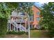 Spacious backyard featuring a deck, a covered patio, and lush landscaping at 5260 Harbury Ln, Suwanee, GA 30024