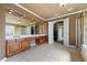 This bathroom includes double sinks, a large mirror with decorative lighting, and a stand-up shower at 5260 Harbury Ln, Suwanee, GA 30024