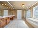 This bathroom includes double sinks, a large mirror with decorative lighting, and a stand-up shower at 5260 Harbury Ln, Suwanee, GA 30024