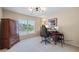 Bright room with a large window, computer, desk, and an armoire at 5260 Harbury Ln, Suwanee, GA 30024