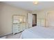Bedroom with a dresser with a mirror and a door leading to the bathroom at 5260 Harbury Ln, Suwanee, GA 30024