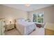 Bedroom with a large window providing natural light and includes a dresser and a desk at 5260 Harbury Ln, Suwanee, GA 30024