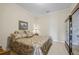 Cozy bedroom with patterned bedding, neutral walls and carpet, with accent lighting and decor display cabinet at 5260 Harbury Ln, Suwanee, GA 30024