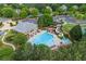 Aerial view showcasing the neighborhood pool with a waterslide, lounge chairs and beautiful landscape surrounding at 5260 Harbury Ln, Suwanee, GA 30024