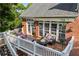 Outdoor deck features patio furniture, a fire pit, overhead string lights, and a retractable awning at 5260 Harbury Ln, Suwanee, GA 30024