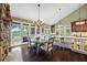 Bright dining area offers natural light with hardwood floors and elegant decor at 5260 Harbury Ln, Suwanee, GA 30024