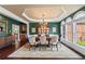 Formal dining room with hardwood floors, decorative molding, and large windows at 5260 Harbury Ln, Suwanee, GA 30024