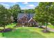 Beautiful brick home with lush green lawn, landscaping, and a welcoming facade at 5260 Harbury Ln, Suwanee, GA 30024