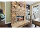 Stacked stone fireplace with glass enclosure and a stone hearth at 5260 Harbury Ln, Suwanee, GA 30024