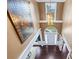Foyer view showing the front door and chandelier, with hardwood flooring at 5260 Harbury Ln, Suwanee, GA 30024