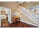 Foyer view highlighting hardwood floors and staircase with white railing and wooden handrail at 5260 Harbury Ln, Suwanee, GA 30024