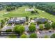 Aerial view of Bear's Best Atlanta Golf Club featuring a driving range and a beautiful landscape of mature green trees at 5260 Harbury Ln, Suwanee, GA 30024