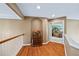 Elegant hallway leading to the bedroom, showcasing hardwood floors and decorative furniture at 5260 Harbury Ln, Suwanee, GA 30024