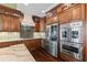 Well-equipped kitchen with stainless steel appliances, custom cabinetry, and countertops, providing ample storage and workspace at 5260 Harbury Ln, Suwanee, GA 30024