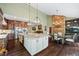Open kitchen includes a dining area with hardwood floors, stainless appliances, and stone fireplace at 5260 Harbury Ln, Suwanee, GA 30024
