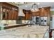 Gourmet kitchen featuring stainless steel appliances, a large island, and beautiful countertops, ideal for cooking at 5260 Harbury Ln, Suwanee, GA 30024