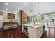 Open kitchen area features hardwood floors, granite countertops, and stainless steel appliances at 5260 Harbury Ln, Suwanee, GA 30024