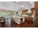 Gourmet kitchen with an island, stainless steel appliances, and natural light, perfect for cooking and entertaining at 5260 Harbury Ln, Suwanee, GA 30024