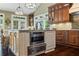 Kitchen island features granite countertops, built-in microwave, and cabinet storage at 5260 Harbury Ln, Suwanee, GA 30024