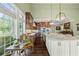 Bright eat-in kitchen features modern appliances, granite counters, and hardwood floors at 5260 Harbury Ln, Suwanee, GA 30024