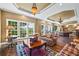 Spacious living room featuring large windows, hardwood floors, and stylish furnishings at 5260 Harbury Ln, Suwanee, GA 30024