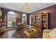 Bright living room featuring hardwood floors, a bookcase, and ample natural light, creating a welcoming ambiance at 5260 Harbury Ln, Suwanee, GA 30024