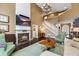 Elegant living room featuring a fireplace, plush seating, and soaring ceilings with decorative chandelier at 5260 Harbury Ln, Suwanee, GA 30024