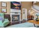 Cozy living room with a fireplace, TV, comfortable seating, and hardwood floors at 5260 Harbury Ln, Suwanee, GA 30024
