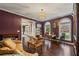 Living room featuring hardwood floors, stylish furniture, and large windows, providing a bright and airy atmosphere at 5260 Harbury Ln, Suwanee, GA 30024