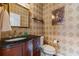 Cozy powder room with vanity and wallpaper at 5260 Harbury Ln, Suwanee, GA 30024