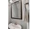Elegant bathroom features a decorative mirror, modern faucet and vanity with stylish towel hanger at 5870 Shiloh Woods Dr, Cumming, GA 30040