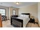 This bedroom features natural light and a black, wooden bed frame, creating an inviting atmosphere at 5870 Shiloh Woods Dr, Cumming, GA 30040