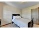 This bedroom features neutral walls and trim and a simple bed frame, promoting simple living at 5870 Shiloh Woods Dr, Cumming, GA 30040