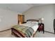 This primary bedroom features a wooden bed frame, gray carpet, and an ensuite bathroom, creating a cozy retreat at 5870 Shiloh Woods Dr, Cumming, GA 30040