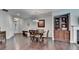 Spacious dining room featuring hardwood floors, a built-in, and natural light at 5870 Shiloh Woods Dr, Cumming, GA 30040