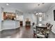 Dining room with hardwood flooring flows to the kitchen with stainless appliances at 5870 Shiloh Woods Dr, Cumming, GA 30040