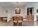 Dining room with hardwood flooring and a decorative light fixture at 5870 Shiloh Woods Dr, Cumming, GA 30040