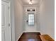 View of the foyer with dark hardwood floors, a transom window, and neutral paint at 5870 Shiloh Woods Dr, Cumming, GA 30040