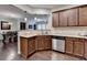 Modern kitchen featuring stainless steel appliances, granite countertops, and a breakfast bar overlooking the dining area at 5870 Shiloh Woods Dr, Cumming, GA 30040