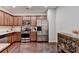 Kitchen with granite counters, stainless appliances, and stylish wooden cabinets at 5870 Shiloh Woods Dr, Cumming, GA 30040