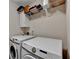 The laundry room boasts new washer and dryer units and shelf and cabinet storage options, providing organization at 5870 Shiloh Woods Dr, Cumming, GA 30040