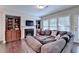 Bright and spacious living room with fireplace, built-in bookcases, and large windows providing ample natural light at 5870 Shiloh Woods Dr, Cumming, GA 30040