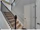 Staircase featuring carpeted steps, decorative iron railing, leading to an upper level at 5870 Shiloh Woods Dr, Cumming, GA 30040