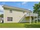 Home exterior featuring a second-story deck, light siding, and a well-maintained lawn at 7169 Sweet Gum Ct, Lithonia, GA 30058