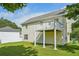 Home exterior featuring a second-story deck, light siding, and a well-maintained lawn at 7169 Sweet Gum Ct, Lithonia, GA 30058