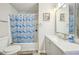 Traditional bathroom featuring a shower and tub combination with framed artwork on the wall and sink vanity at 7169 Sweet Gum Ct, Lithonia, GA 30058