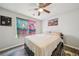 This bedroom is equipped with a ceiling fan to keep cool and comfortable with posters on the wall at 7169 Sweet Gum Ct, Lithonia, GA 30058
