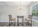 Cozy dining area with modern table and chairs near window and door at 7169 Sweet Gum Ct, Lithonia, GA 30058
